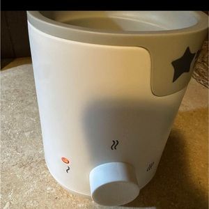 Small grey and white baby bottle warmer.